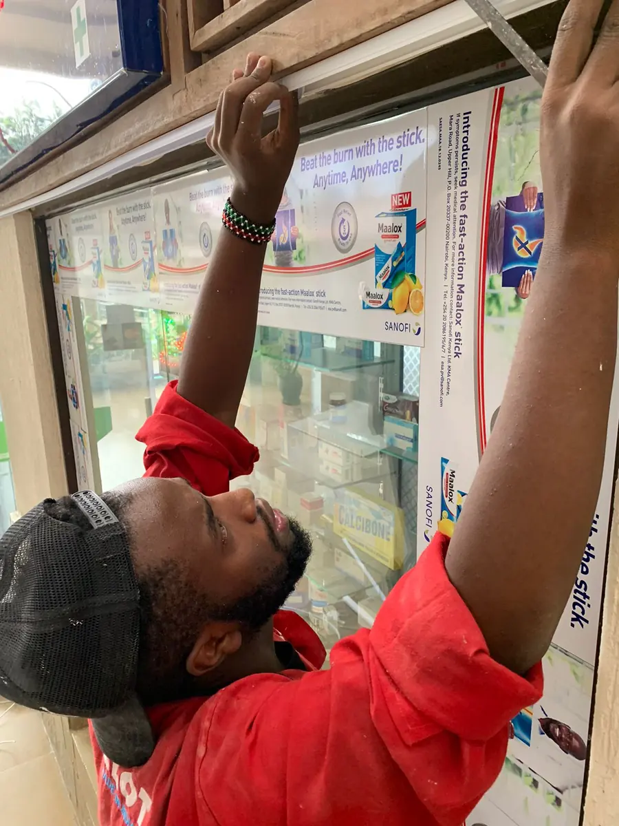 Regisam Technologies technician installing equipment in a client's shop